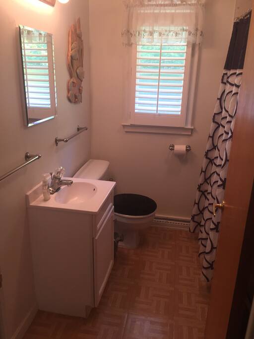 Full bathroom with showerhead and tub.