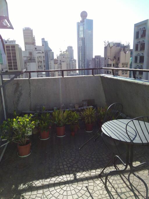 Sunny roof terrace with table and chairs