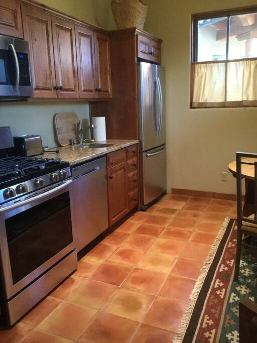 Kitchen with all new appliances, seen from bedroom door.