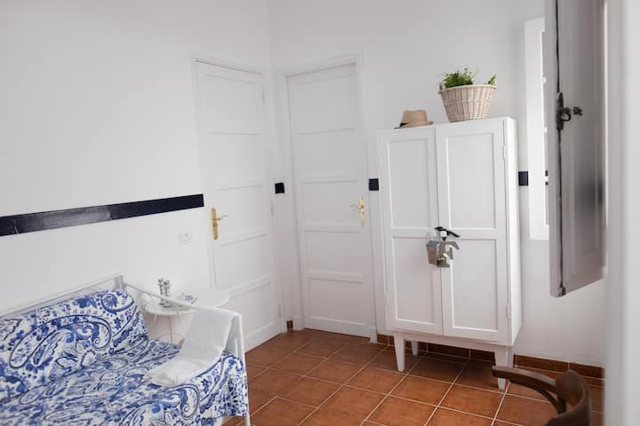 Olive bedroom with sofa bed and bathroom