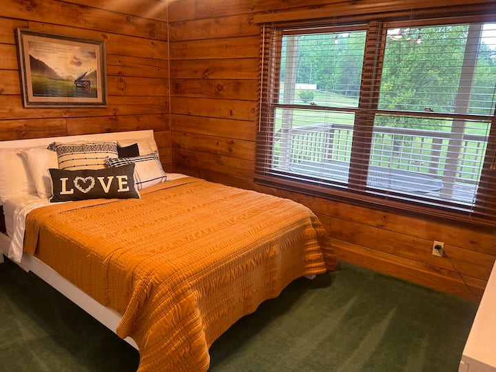 The Music Lovers bedroom has a comfortable queen size bed, a large dresser with a wide mirror, a full length mirror, a closet, and a beautiful view of the front yard. The closet also has plenty of games and books for you and  your guests to enjoy.
