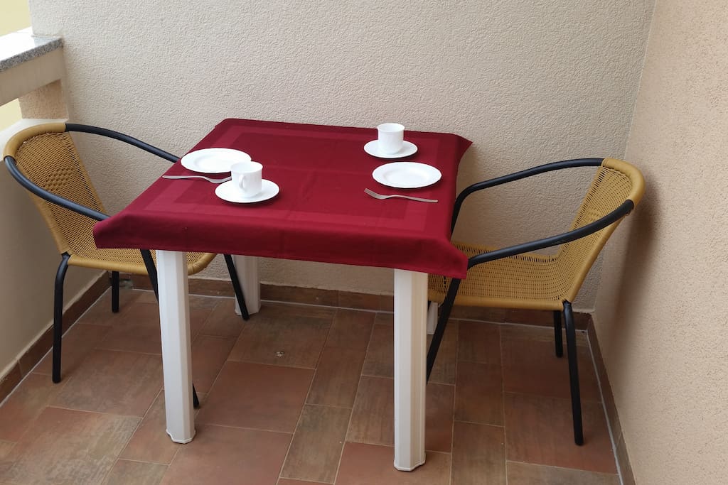 Balcony with table and chairs.