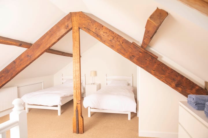 Twin beds in the 1st upstairs bedroom set under beautiful eaves.  There is plenty of head space in the middle.