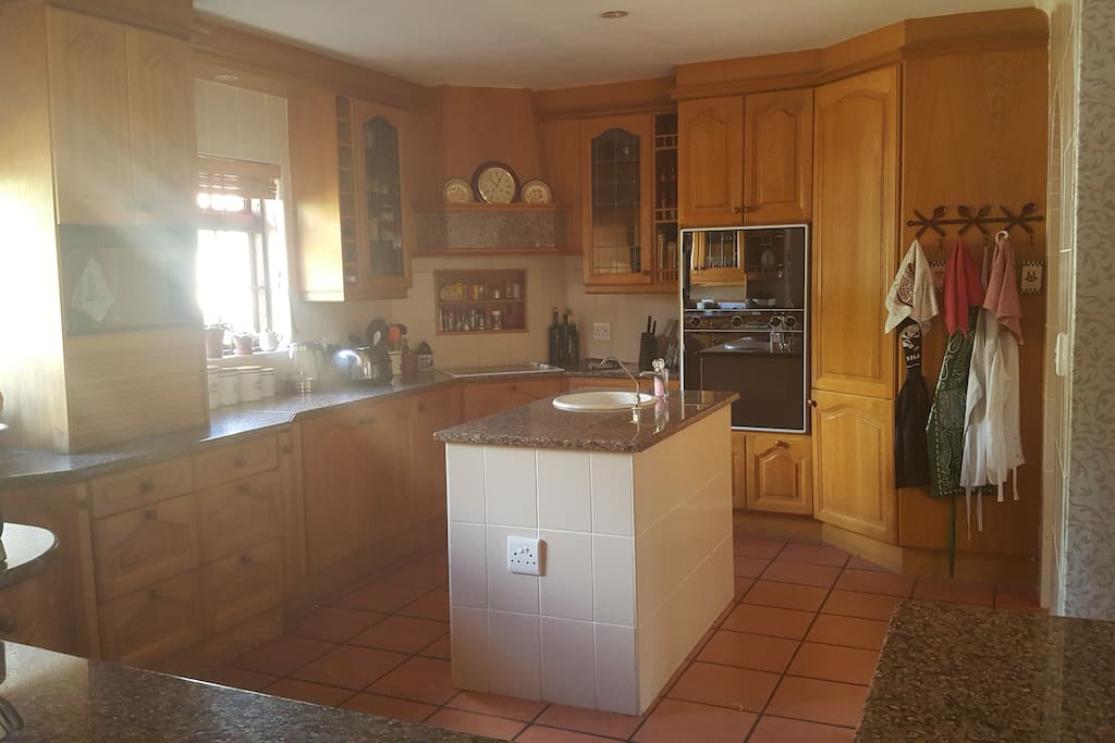 Large kitchen with separate scullery containing fridge, dishwasher, washing machine and dryer