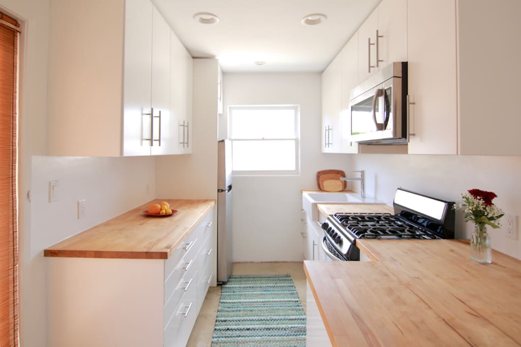 Full kitchen with plates, utensils, glasses, etc.