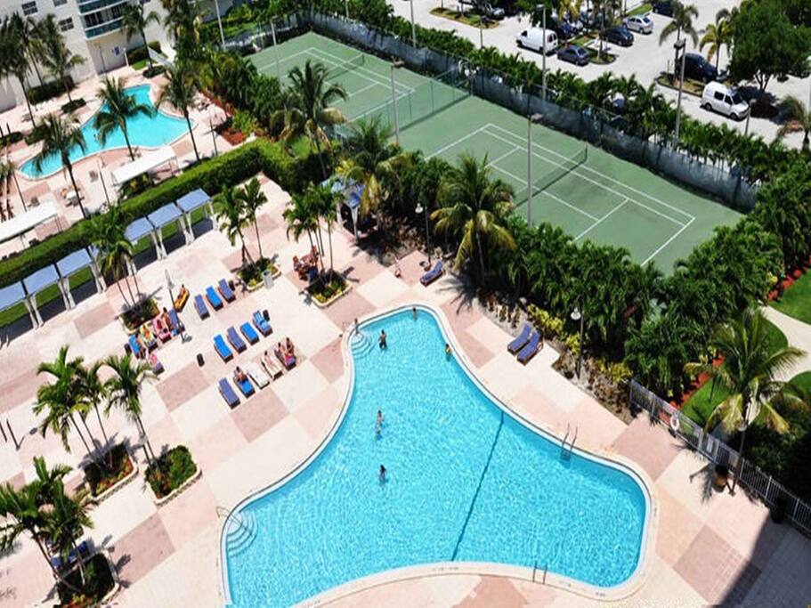 View of the magnificent tennis courts and the condo's outdoor heated pools