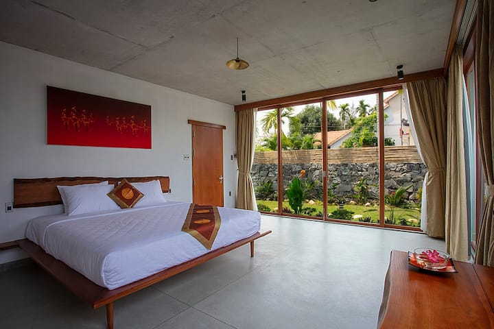 Chumba cha kulala cha ghorofa ya chini kinachoangalia bustani ya kibinafsi.