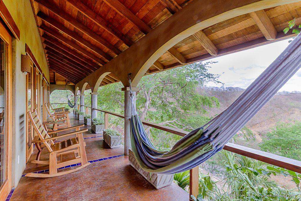 Front veranda with two hammocks and rocking chairs