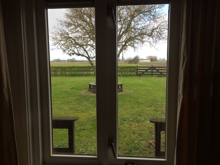 View from the bedroom window; private terrace and garden overlooking pastures