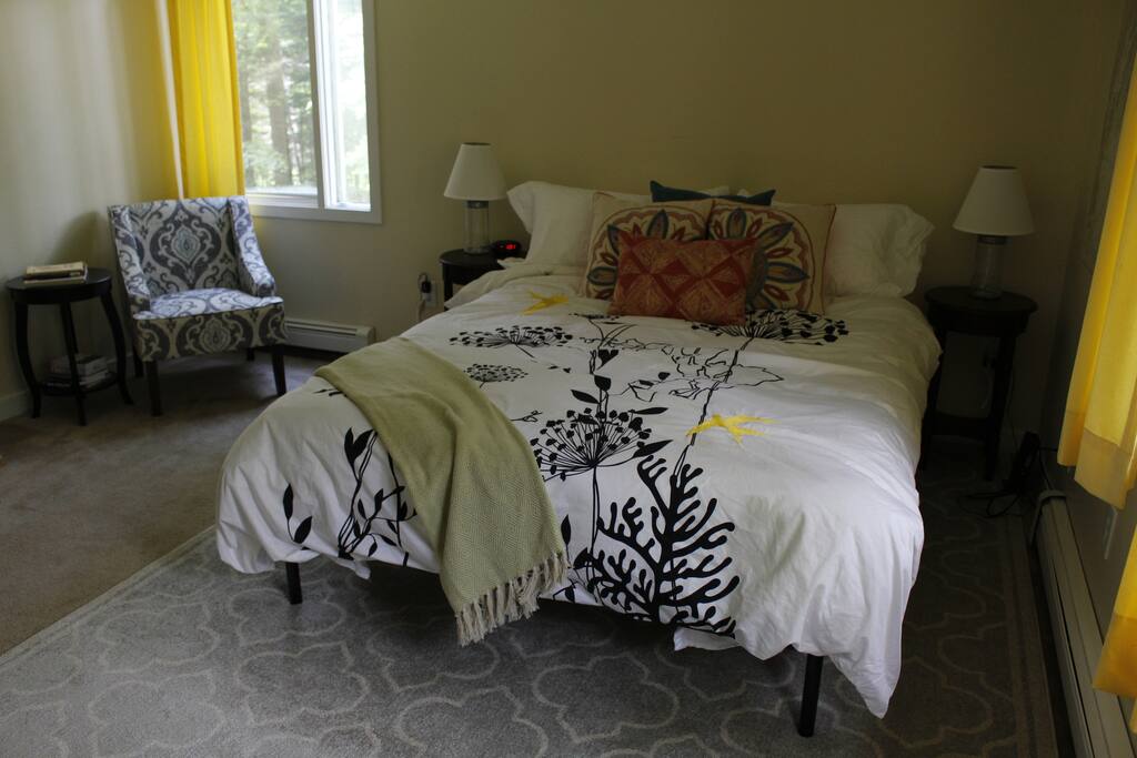 Queen size memory foam mattress and a cozy corner for reading by the window