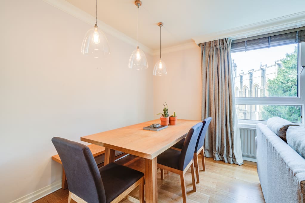 Very large living room with dining table, sofas, TV