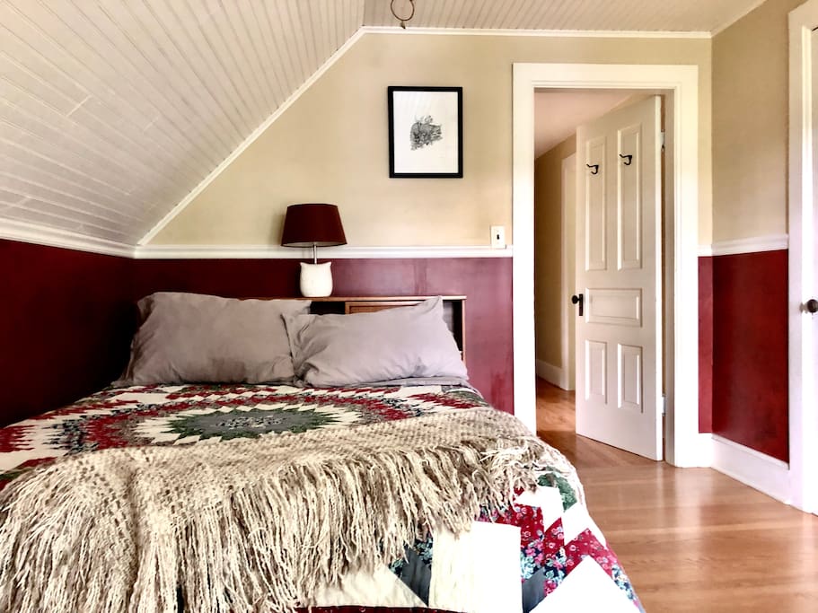 The bedroom: a full size bed with ‘60s era headboard and matching dresser. Additional closet space, ironing board and iron.