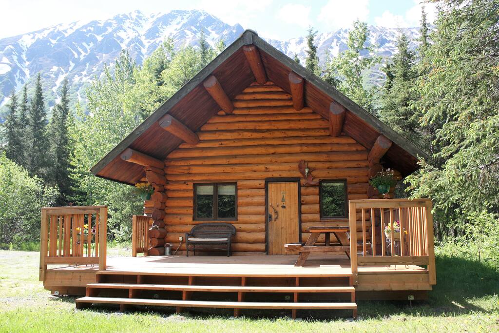View of the outside of the log cabin's relaxing front porch.