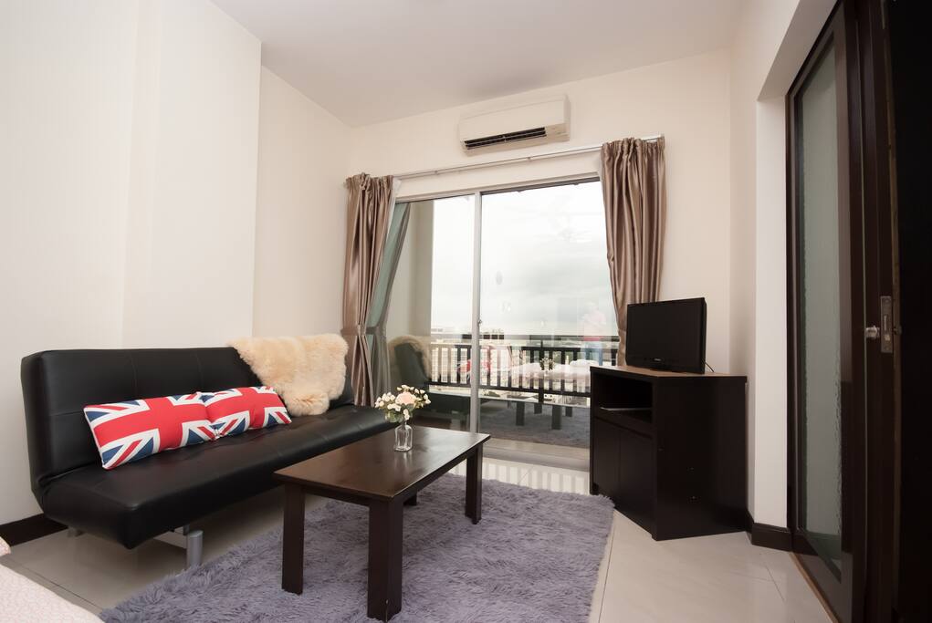 Living hall with sofa bed and TV