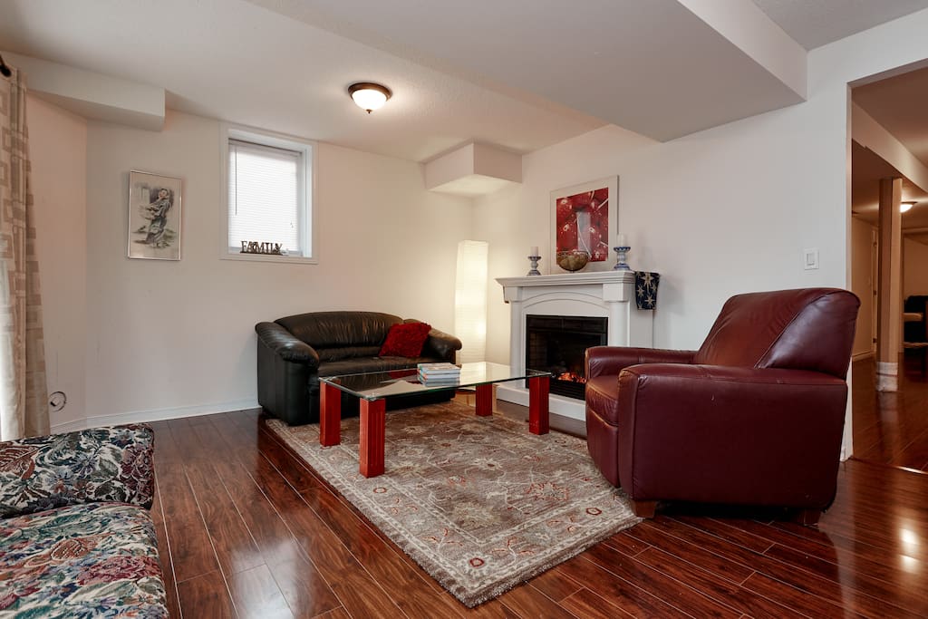 The sitting area has a leather two seater couch and reclining chair.