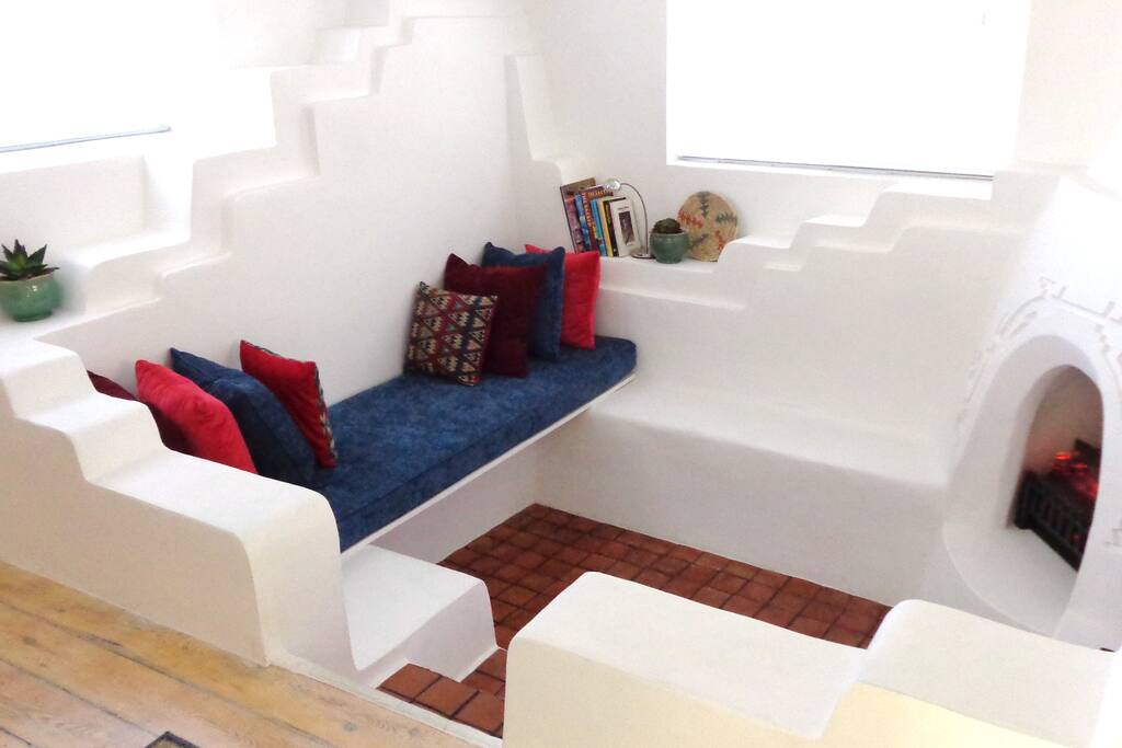 The sitting area within the sunken living room, fireplace on right.