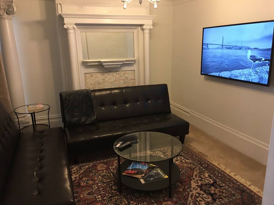 55 inch TV, and leather sof1as in living room