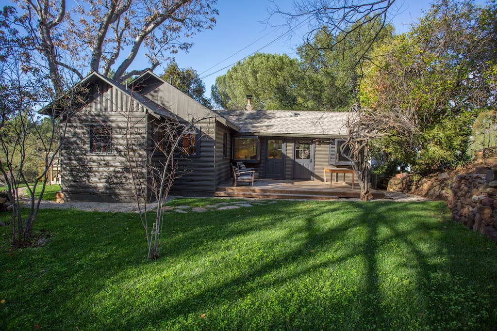 Grassy back yard and deck with outside dining