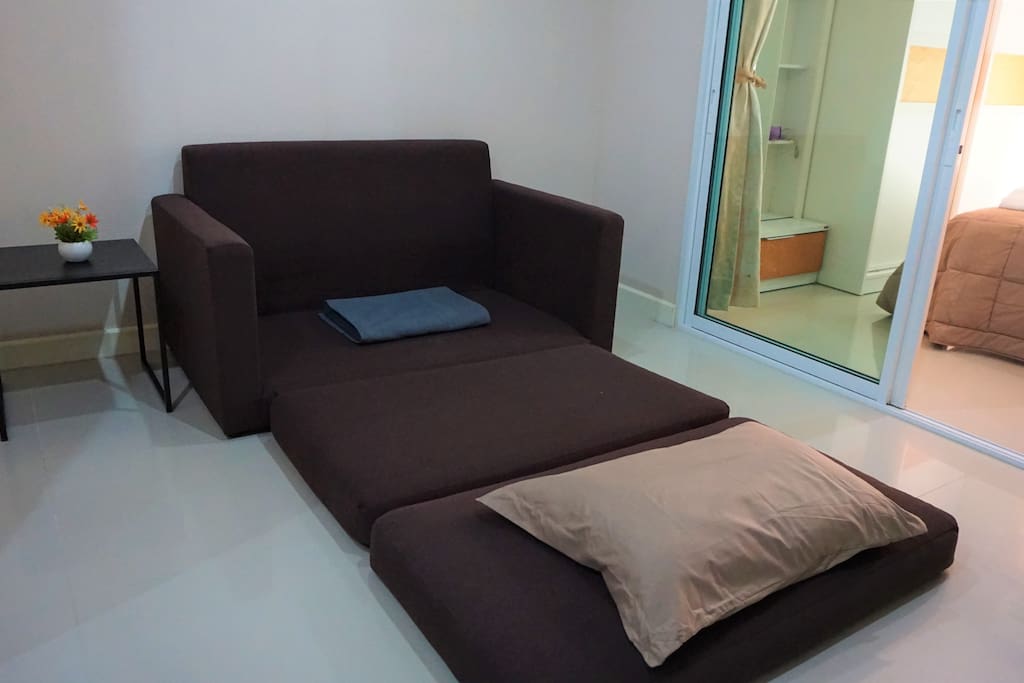 Sofa bed for extra person with additional pillow and blanket