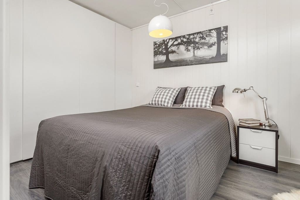 The bedroom is spacious and equipped with a queen size bed