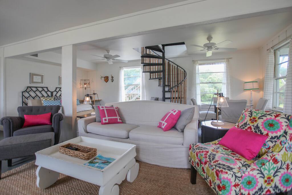 living room with a view of the stairs leading to the bedrooms