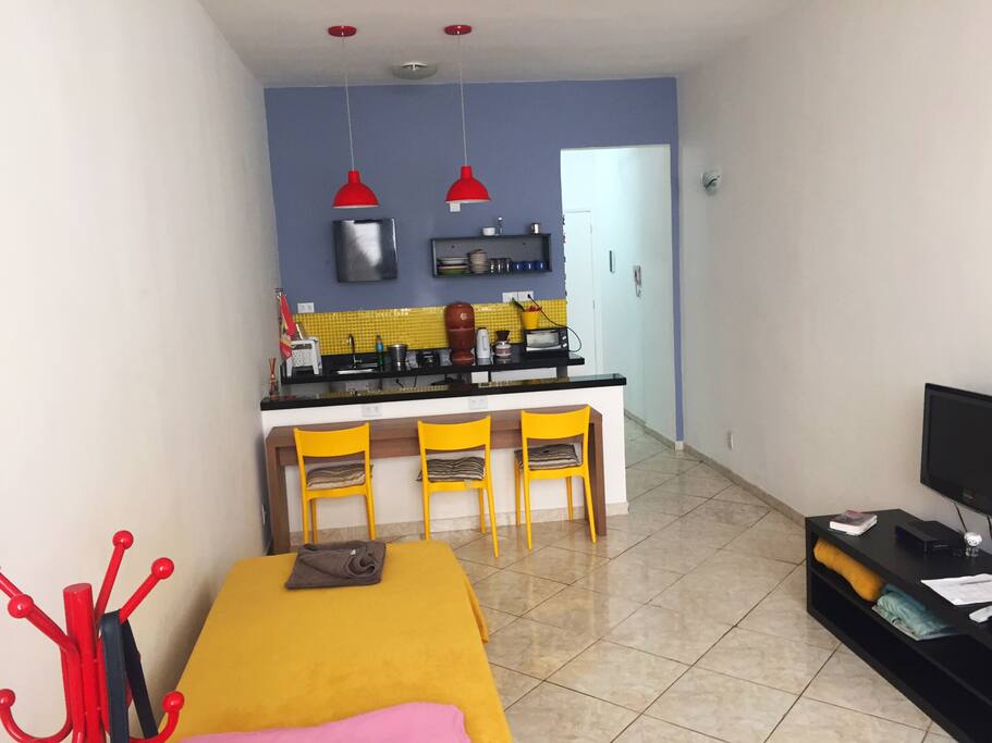 Uma das camas e vista da cozinha
