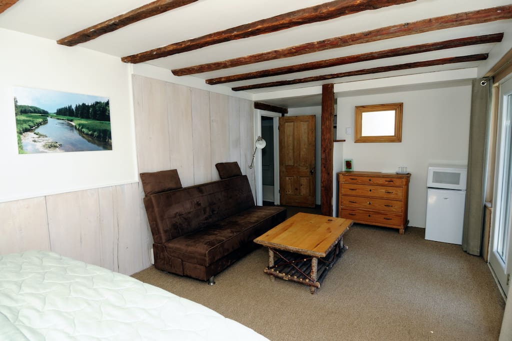 The Annex Suite has a king bed, sitting area, private 4 piece bathroom, mini-fridge, microwave oven, and private deck overlooking the Northumberland Strait.