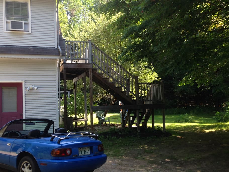 Side view of parking area, private entrance and deck