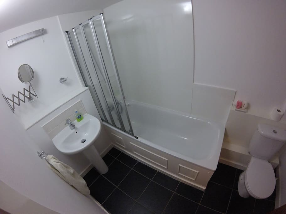Downstairs bathroom with full bath and overhead shower