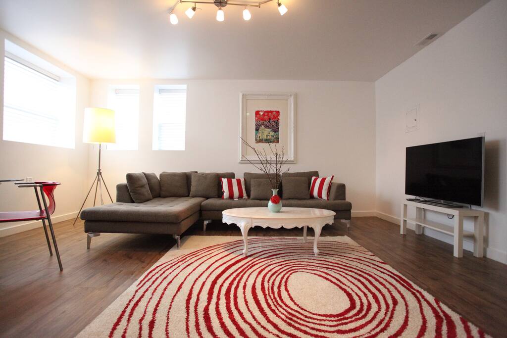 Modern open layout with kitchen, dining, living room space. 4 dining room chairs, and 2 barstools at the butcher block.