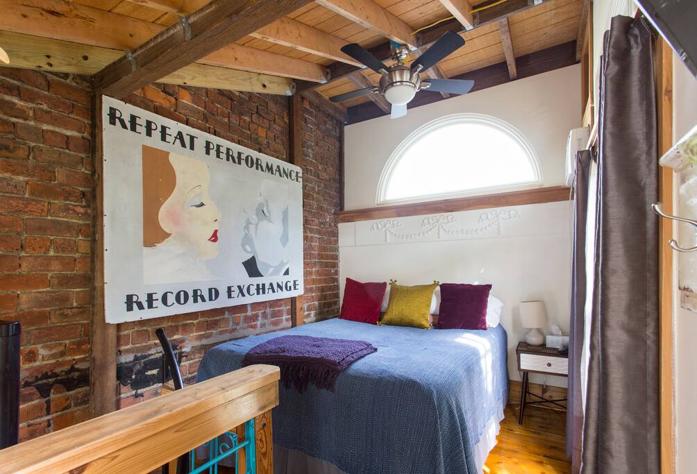 Upstairs loft with queen size bed and TV.