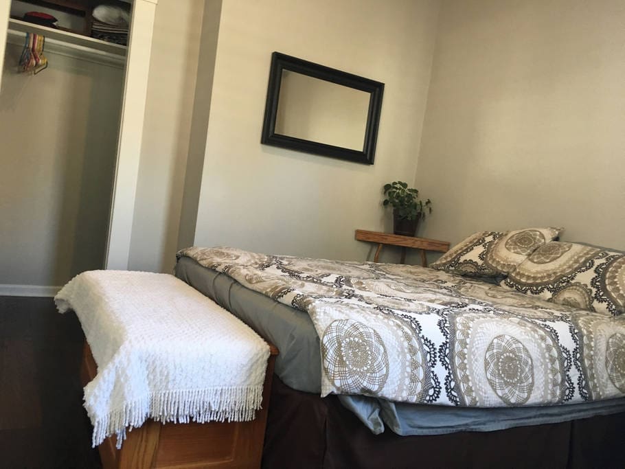Your bedroom features a comfortable queen bed, love seat, iron/ironing board, house manual, water, snacks, toiletries, and brochures about our favorite Indy attractions.