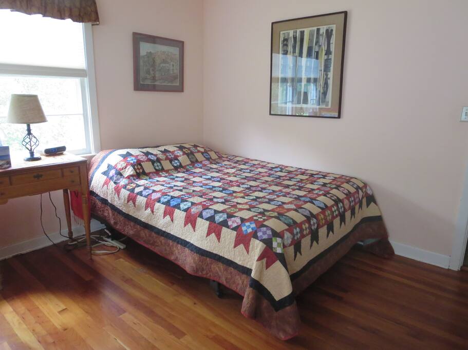 Room #1 with queen bed, two desks, night table, dresser