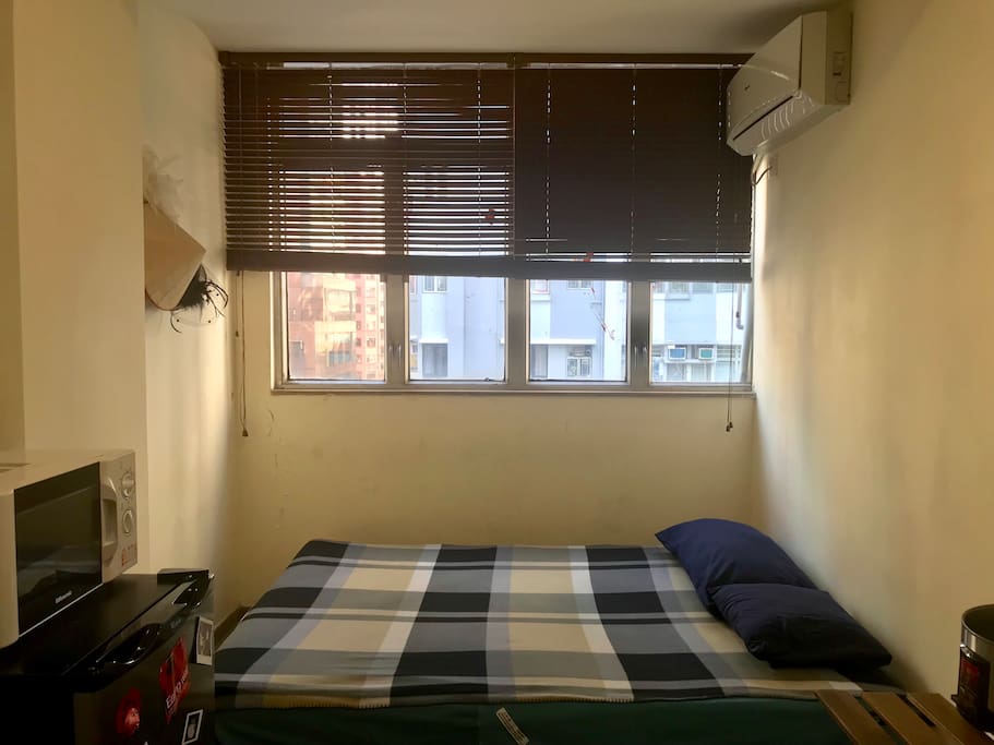 The bed is close to the window....the room has microwave , fridge, air cond