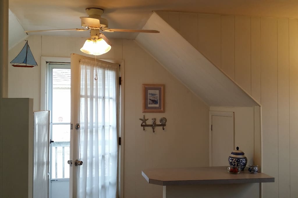 The dining counter with two stools is across from the kitchen.
Next to the door you'll find to borrow: a beach bag with 2 beach tags, towels and a sand mat. Two beach chairs are in the closet along with grill utensils.