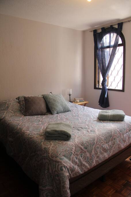 Private bedroom with queen bed and natural lighting