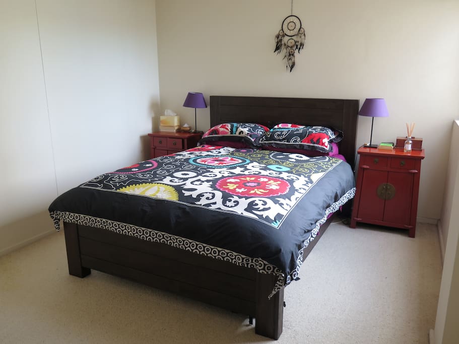 Queen bed in sunny double room.