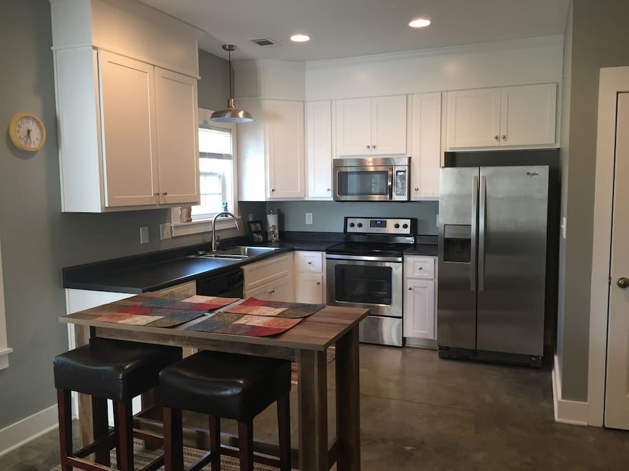 Kitchen with stainless steel appliances and breakfast bar