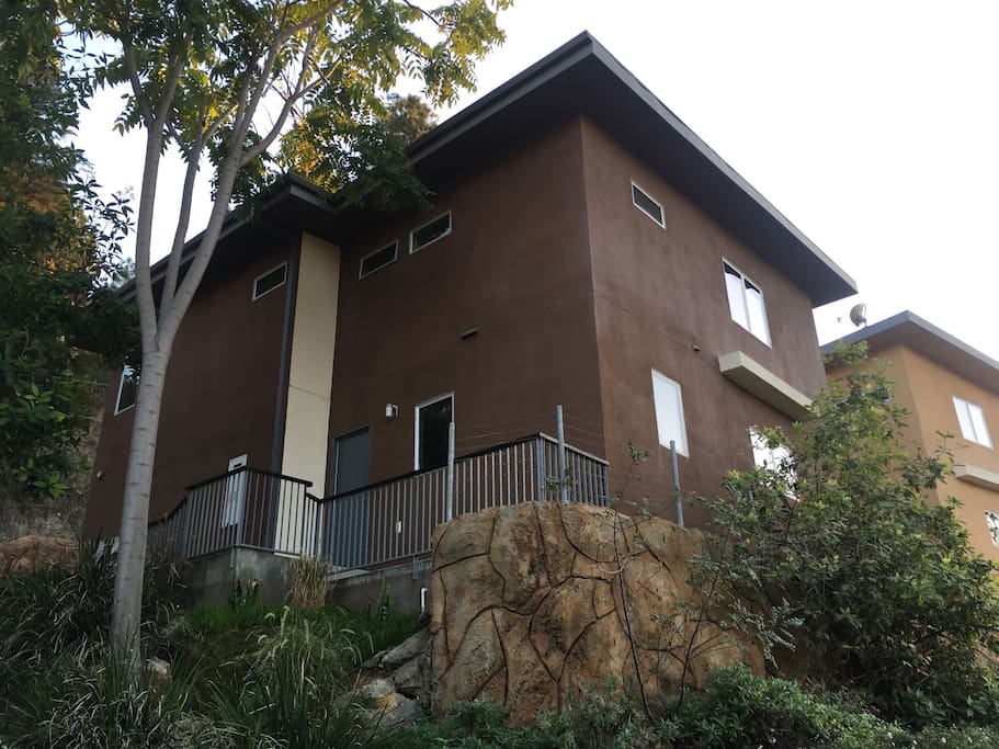 View of my home from the side. The street curves up a hill to get to the front of the home.