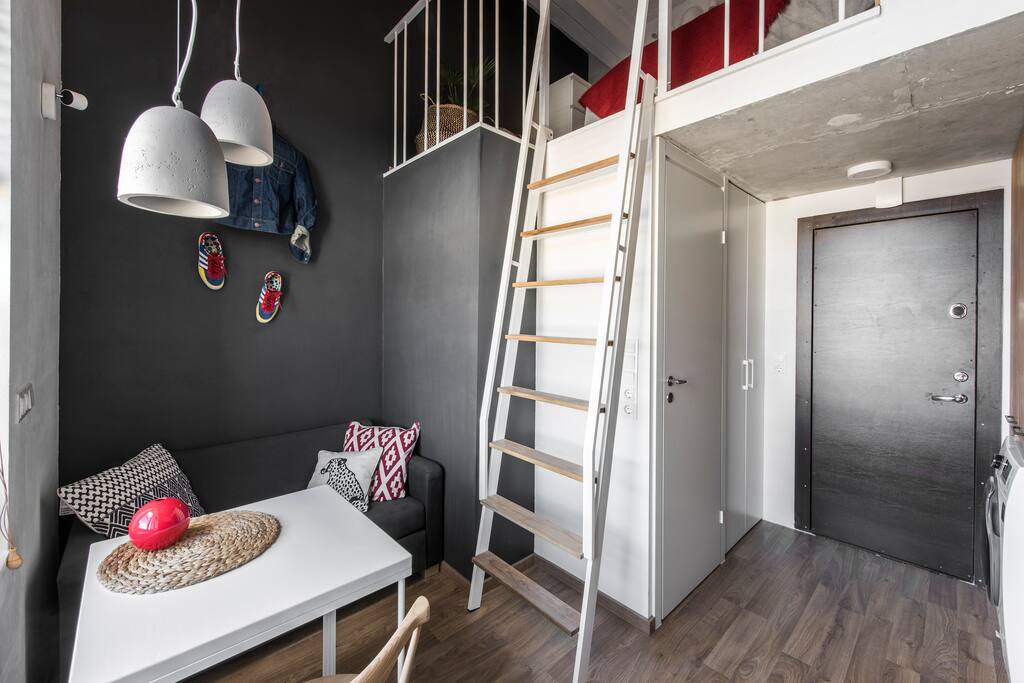 Living area with ladder leading to the 2nd level.