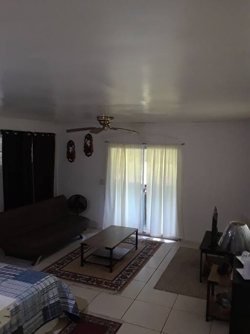 living room area with A.C. and wifi for additional comfort and convenience. Sliding window leads to sunroom.
