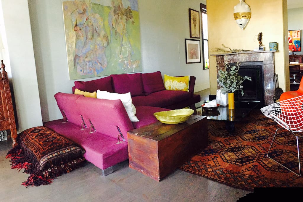 Spacious and comfortable down filled sofa with eclectic art and antic furniture