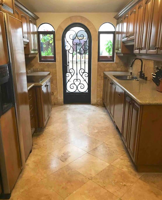 This kitchen is fully equipped with modern appliances and granite counter tops. Off the kitchen patio is the laundry room with a full washer/dryer. Please help yourself to the fresh potted herbs on the patio.