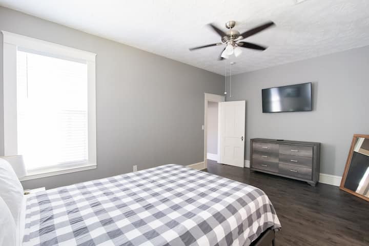 Large master bedroom has queen sized bed that boast a memory foam topper
