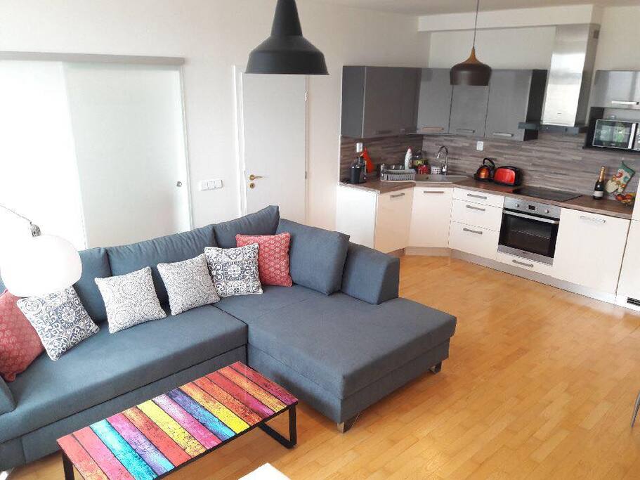 Living room with a large sofa bed & the kitchen