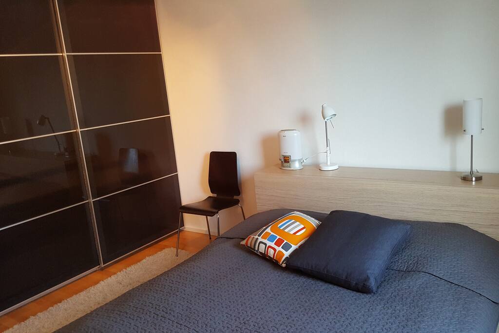 There is a big wardrobe, wake-up light and bedside lamps in the bedroom