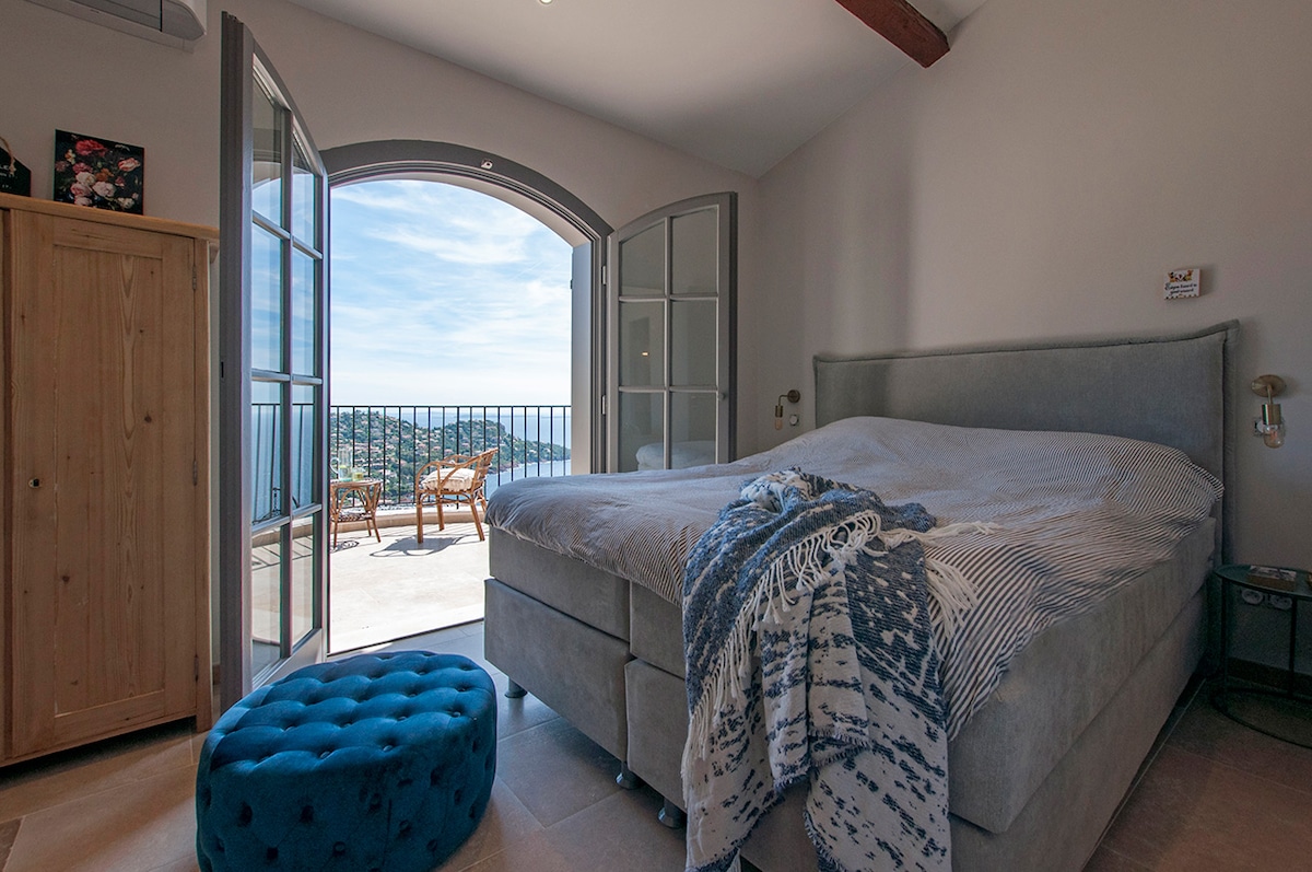 The right bedroom at the top floor,  both of the rooms have an amazing view over Nice and Cannes. Every room has there own shower and toilet. The bathrooms are covered in colorful tiles. We kept the authentic wooden beams, the rooms are very cozy.