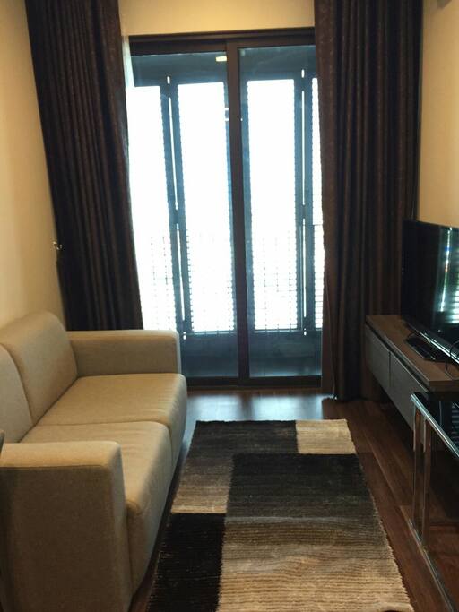 The living room and balcony which you can open the window to enjoy a view of the city.