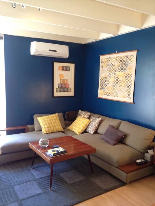 Living room featuring comfortable couch & air conditioning/heating.
