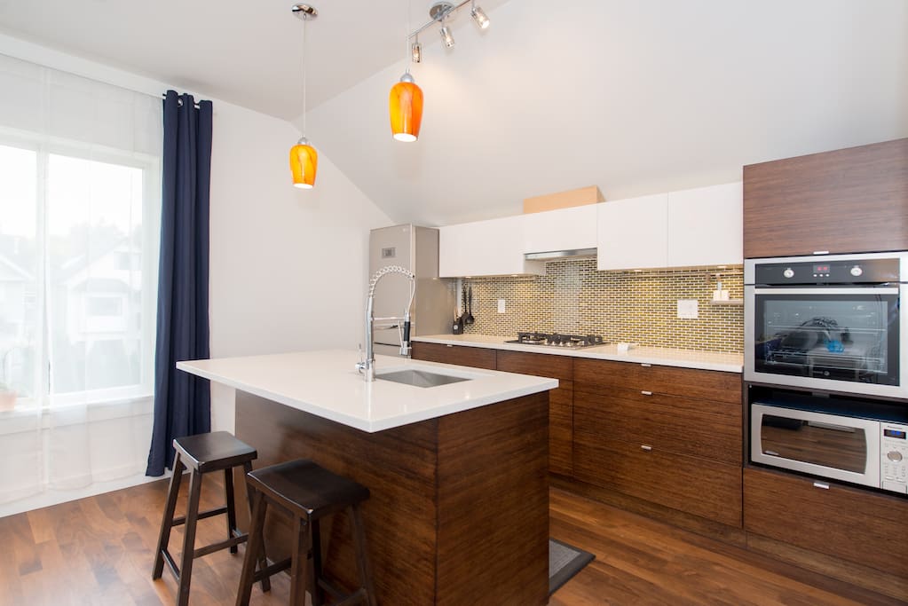 2 bar stools pull up to the kitchen island for meals